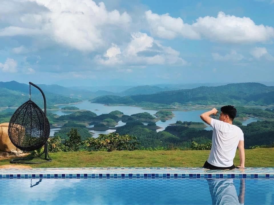 Du khách ngồi bên hồ bơi nhìn ra hồ Tà Đùng